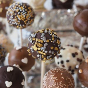 Close-up of assorted cake pops with chocolate and decorative toppings perfect for dessert tables.